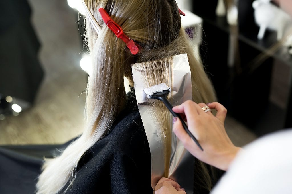 Process of dyeing hair at beauty salon.
